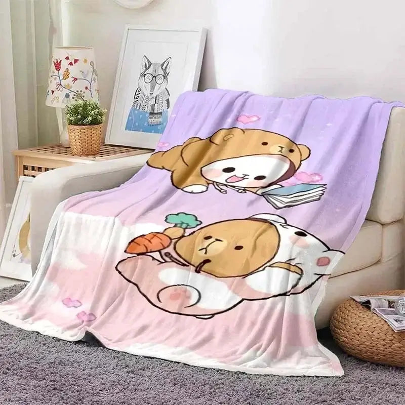 Cozy Bubu and Dudu blanket featuring cute animal characters on a pastel-colored throw, perfect for snuggling on the couch.