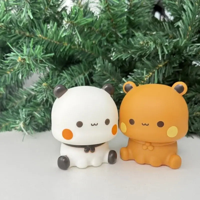 Bubu and Dudu lamp figurines in front of green foliage, cute design perfect for night light decor.